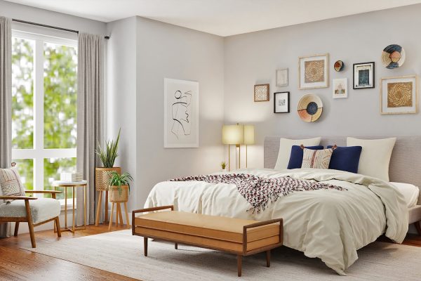 black laptop computer on white bed